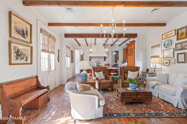 living room featuring beam ceiling, brick floor, visible vents, and a notable chandelier