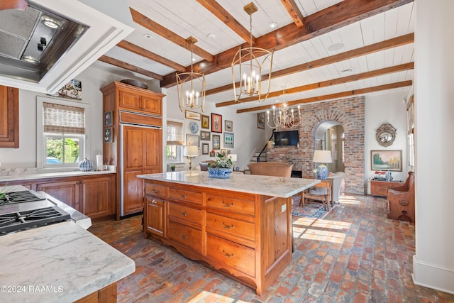 kitchen featuring paneled built in refrigerator, arched walkways, brown cabinetry, and open floor plan