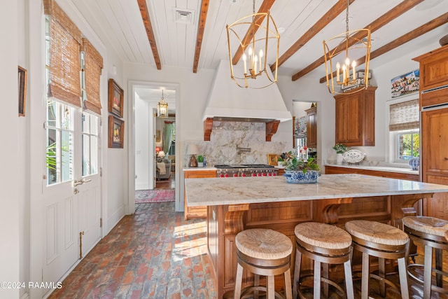 kitchen with brick floor, visible vents, decorative backsplash, beam ceiling, and brown cabinets