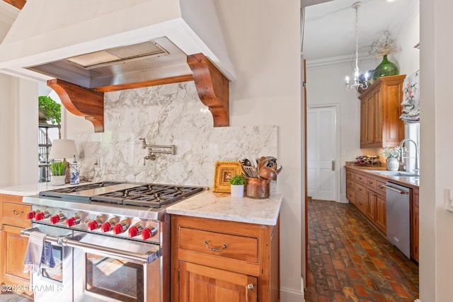 kitchen with brick floor, stainless steel appliances, a sink, backsplash, and brown cabinets