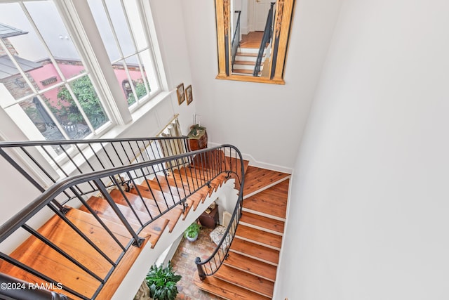 staircase with baseboards and wood finished floors