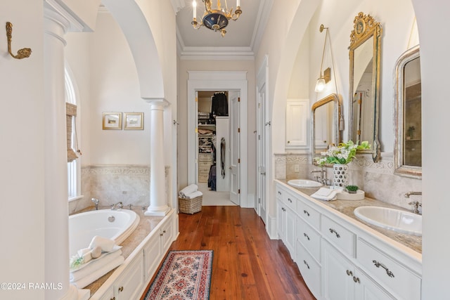 bathroom with ornamental molding, a sink, and decorative columns