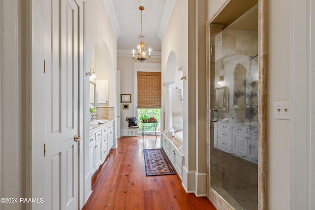 interior space with crown molding, hardwood / wood-style floors, and an inviting chandelier