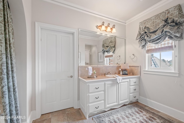 bathroom with baseboards, backsplash, vanity, and crown molding