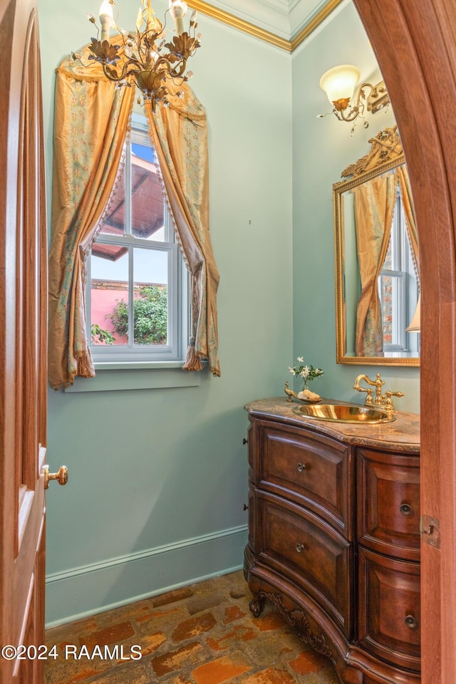 interior space with baseboards, crown molding, and vanity