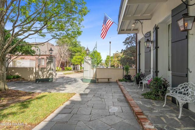 view of patio featuring fence and a gate