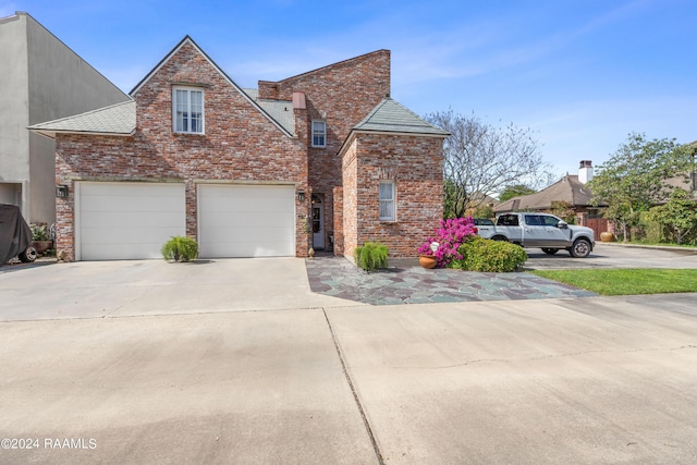 view of front of house with concrete driveway and brick siding