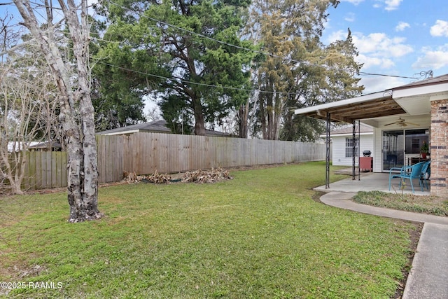 view of yard with a fenced backyard, a ceiling fan, and a patio