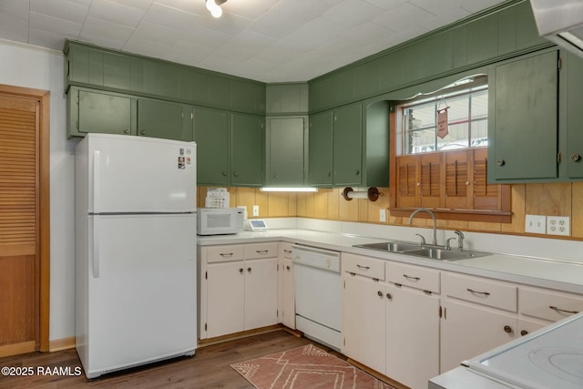 kitchen featuring white appliances, dark wood-style flooring, a sink, white cabinetry, and light countertops