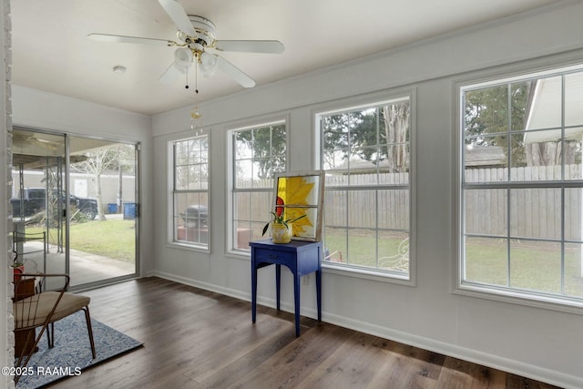 sunroom featuring a healthy amount of sunlight and a ceiling fan