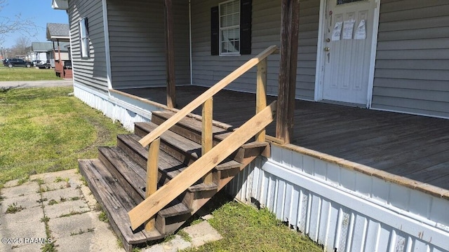 doorway to property with a lawn