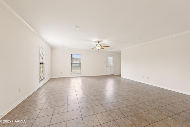 empty room with baseboards, crown molding, and ceiling fan