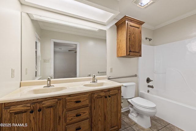 full bath with a sink, toilet, double vanity, and tile patterned flooring