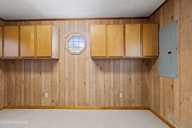 unfurnished room with electric panel, light floors, and baseboards