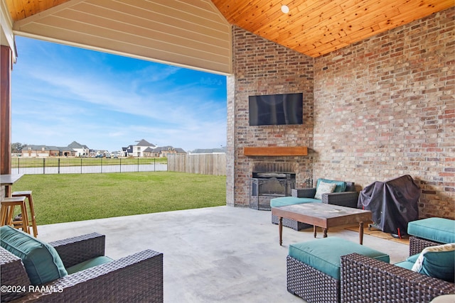 view of patio featuring an outdoor living space with a fireplace, a fenced backyard, and a residential view