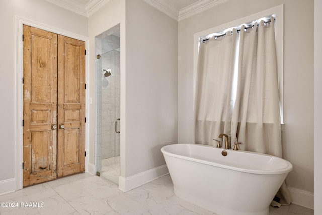 full bath featuring marble finish floor, crown molding, a shower stall, a freestanding tub, and baseboards