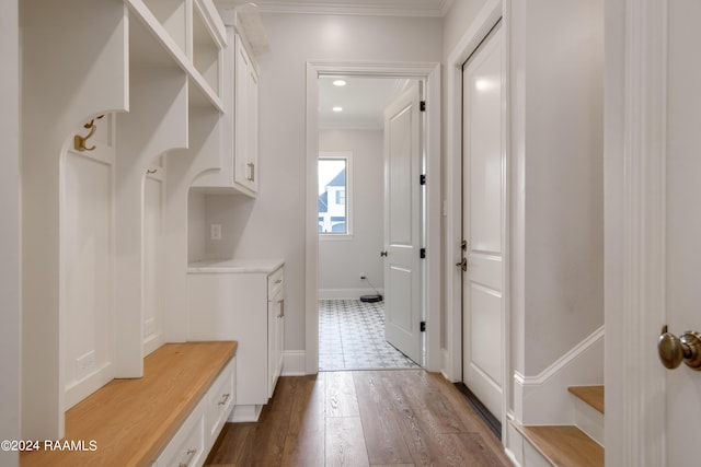 mudroom featuring dark wood-style floors, ornamental molding, and recessed lighting