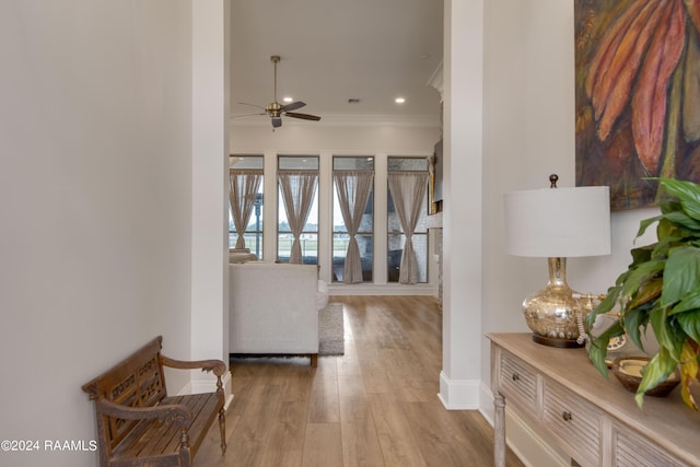 hallway featuring ornamental molding, recessed lighting, wood finished floors, and baseboards