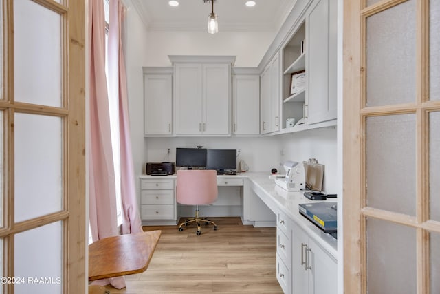 office area with ornamental molding, recessed lighting, built in study area, and light wood-style floors