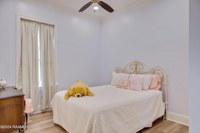 bedroom featuring baseboards, ceiling fan, ornamental molding, and light wood-style floors