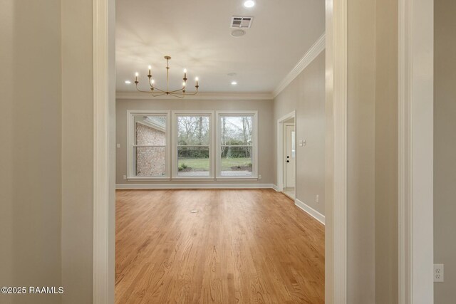 interior space featuring baseboards, visible vents, light wood-style flooring, crown molding, and a notable chandelier