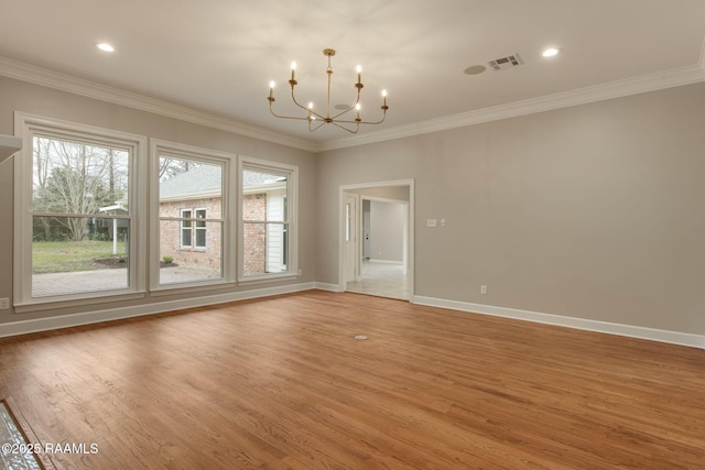 empty room with an inviting chandelier, light wood-style flooring, and ornamental molding