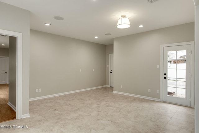 unfurnished room featuring recessed lighting and baseboards