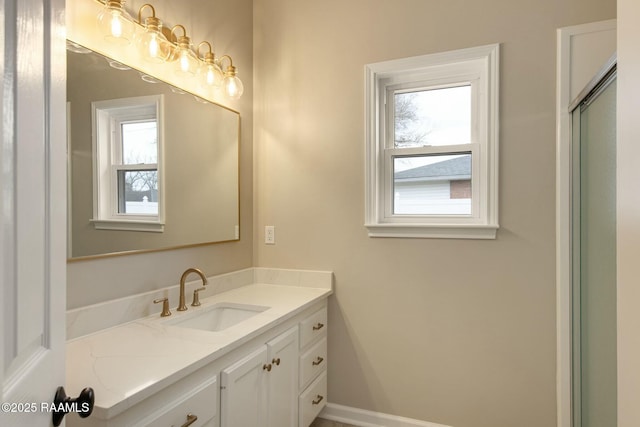 bathroom with vanity and baseboards