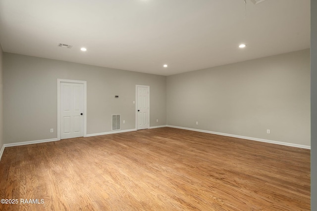 spare room with baseboards, recessed lighting, visible vents, and light wood-style floors