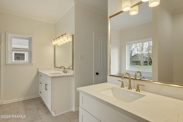 bathroom featuring ornamental molding, two vanities, a sink, and baseboards