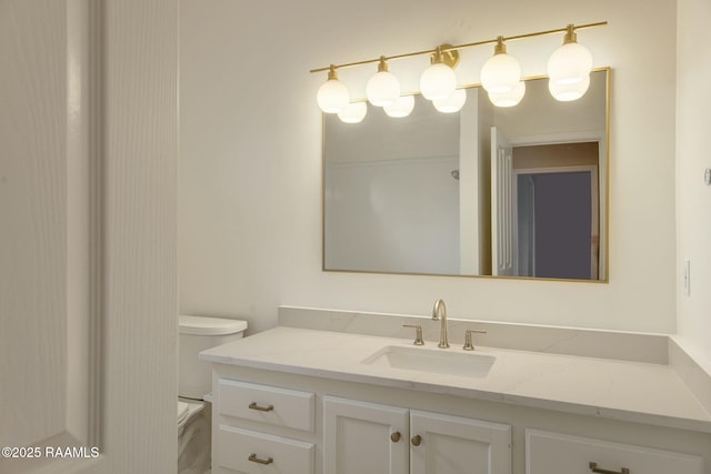 bathroom featuring toilet and vanity