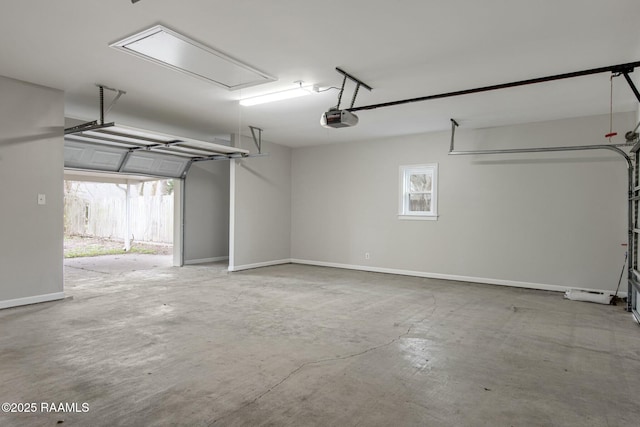 garage with baseboards and a garage door opener