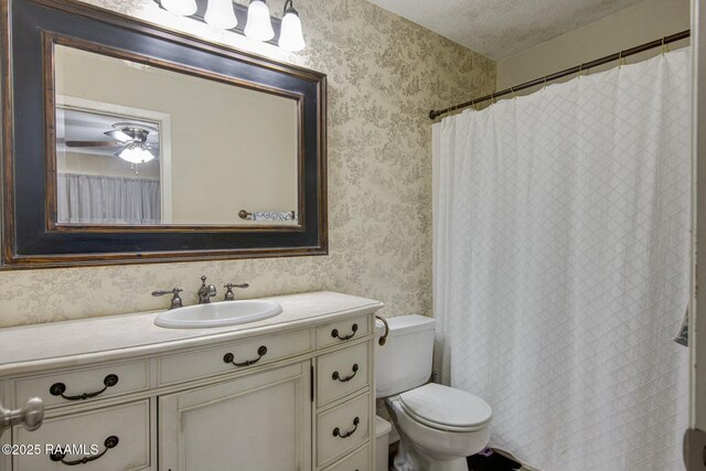 110 W Bayou Pkwy Unit 401, Lafayette, LA 70503 - bathroom featuring wallpapered walls, a textured ceiling, vanity, and toilet