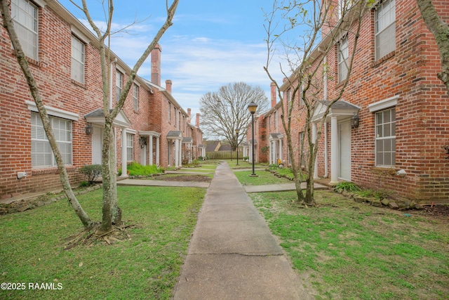 view of property's community featuring a yard