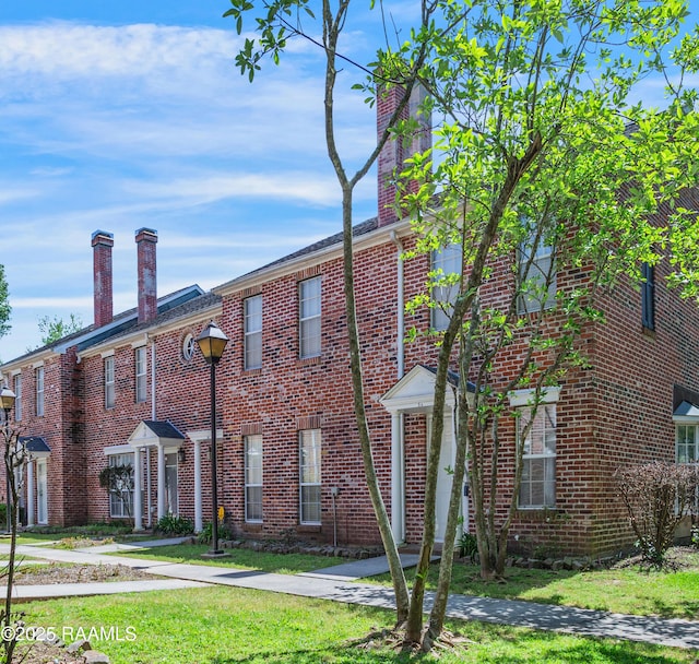 416 Doucet Rd Unit 5A, Lafayette, LA 70503 - view of front of home with brick siding and a chimney