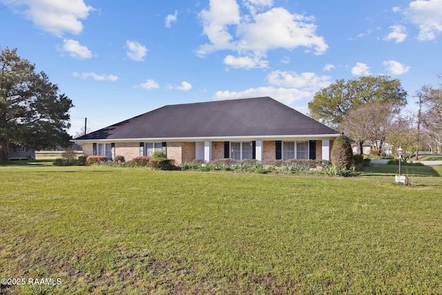 exterior space with a yard and brick siding