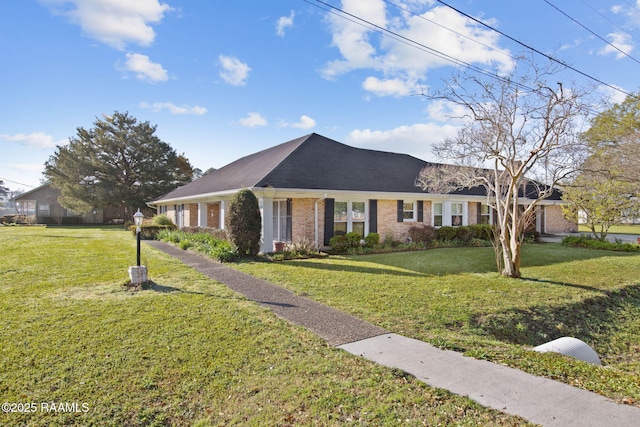 view of front facade with brick siding and a front yard