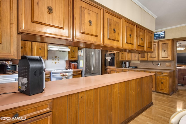 kitchen with ornamental molding, electric stove, black oven, freestanding refrigerator, and brown cabinetry