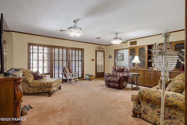 carpeted living area featuring an inviting chandelier, crown molding, and visible vents