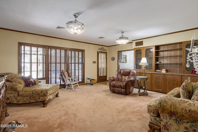 living area with light carpet, visible vents, an inviting chandelier, and ornamental molding