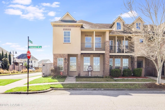 view of property featuring brick siding and stucco siding