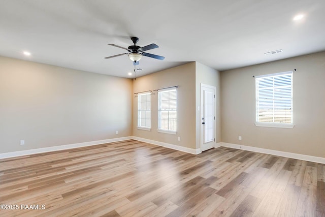 spare room featuring a ceiling fan, visible vents, baseboards, light wood finished floors, and recessed lighting