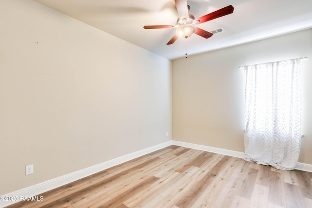 unfurnished room featuring visible vents, baseboards, light wood-style flooring, and a ceiling fan