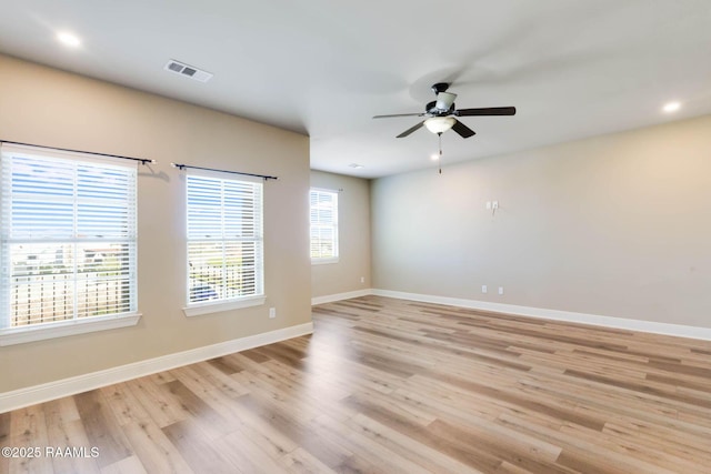 empty room featuring visible vents, baseboards, recessed lighting, light wood-style floors, and a ceiling fan