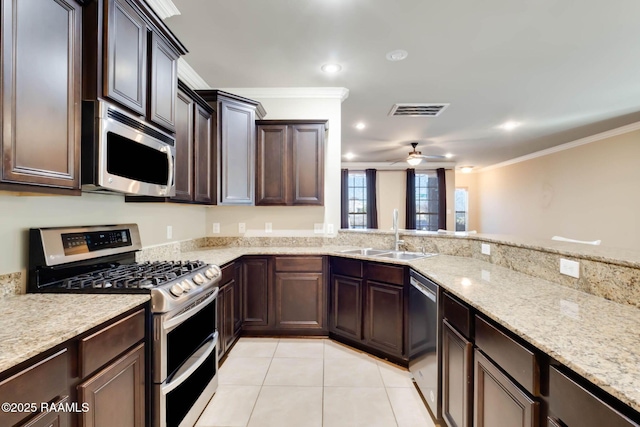 kitchen with visible vents, crown molding, light tile patterned floors, stainless steel appliances, and a sink