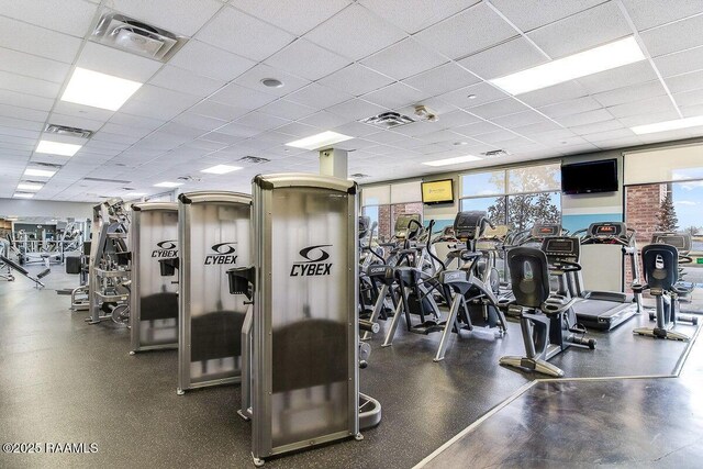 workout area with visible vents, plenty of natural light, and a drop ceiling