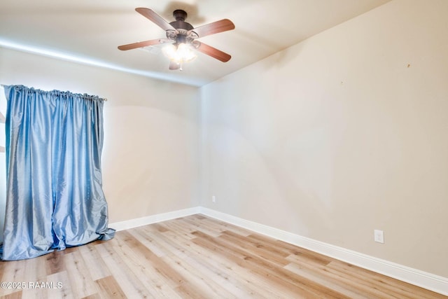 unfurnished room featuring light wood finished floors, a ceiling fan, and baseboards