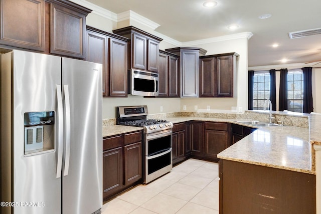 kitchen with ornamental molding, appliances with stainless steel finishes, a peninsula, and a sink