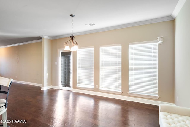 unfurnished dining area with visible vents, wood finished floors, crown molding, baseboards, and a chandelier