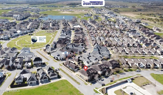 bird's eye view with a residential view and a water view